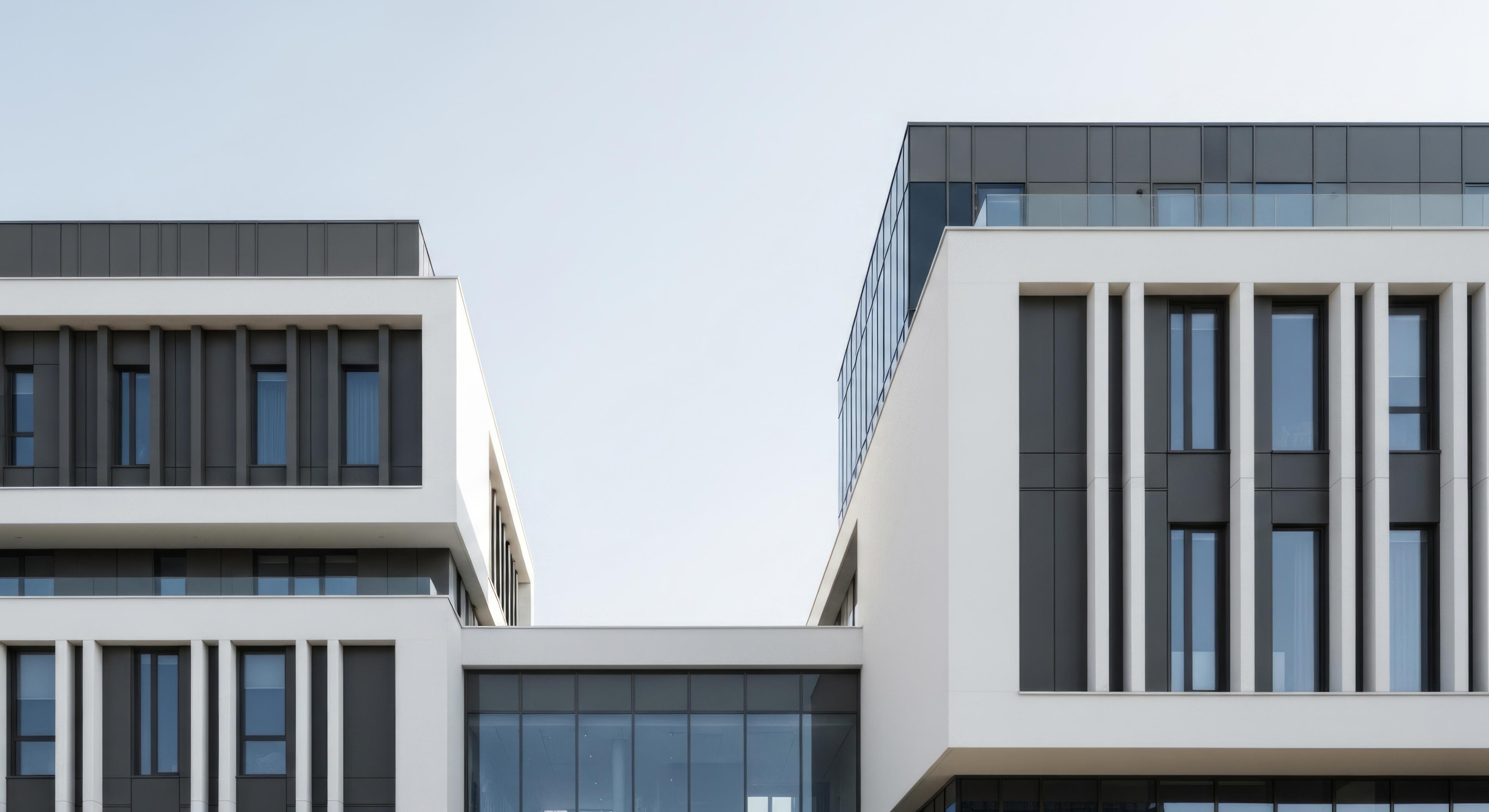 Modern residential building with a geometric white facade under a clear sky